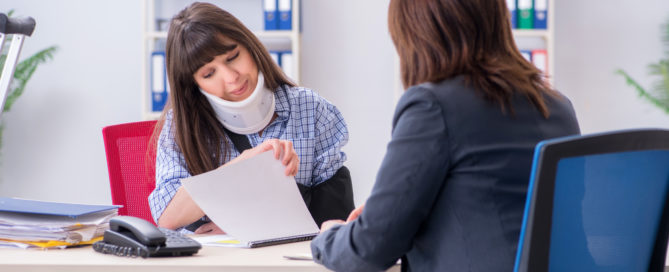 woman with a personal injury consulting a personal injury lawyer about her claim